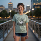 Unisex light green cotton t-shirt featuring a distressed graphic of a frog relaxing on a lily pad.
