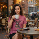 Woman wearing a pink t-shirt with a distressed cowboy raccoon graphic and the text Well Sheeyit.