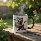 Accent mug featuring a raccoon holding a coffee cup with flying beans, on a wooden table.