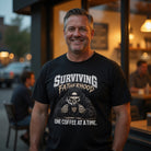 Man wearing a black t-shirt with a skull drinking coffee and 'Surviving Fatherhood' graphic.