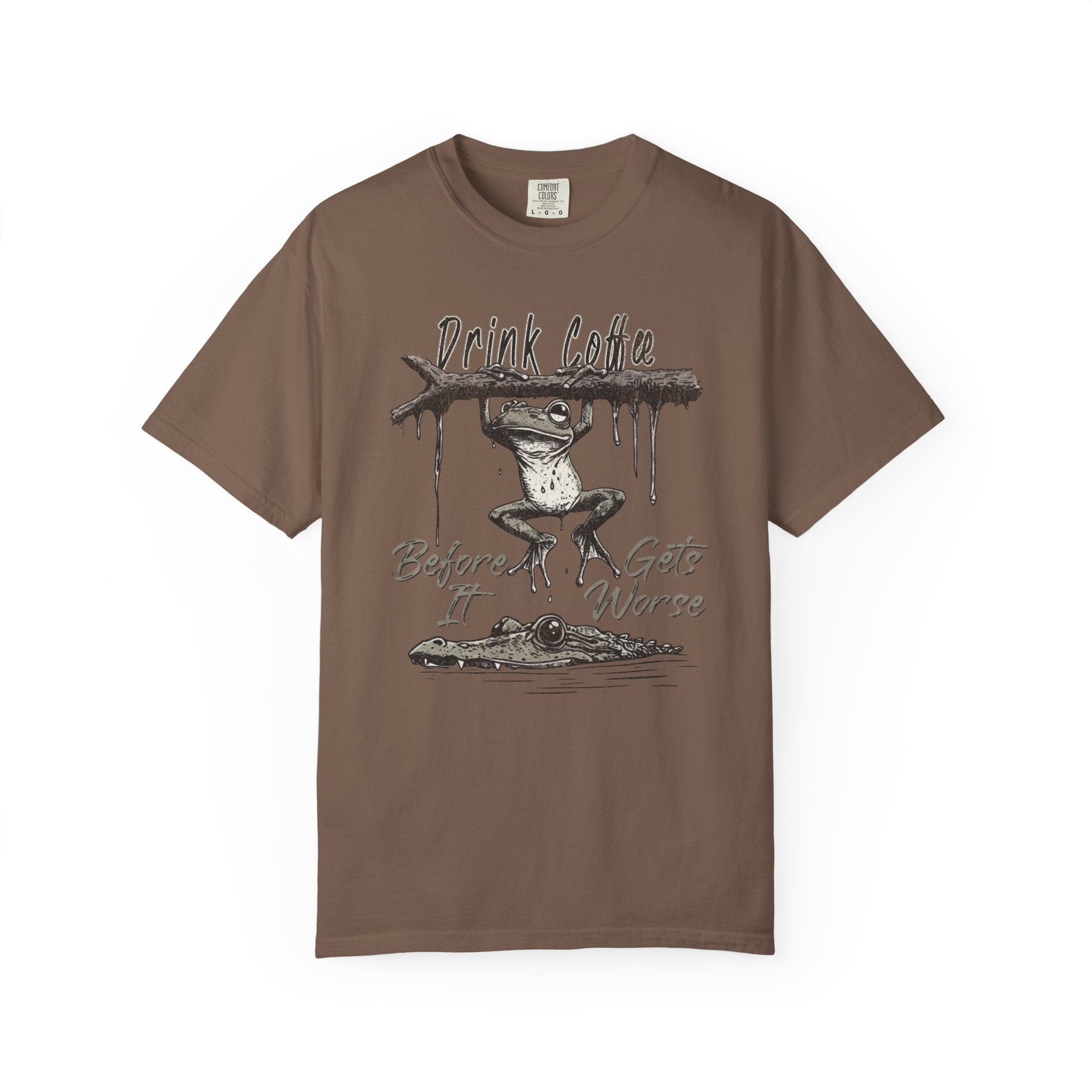 Brown unisex t-shirt featuring a graphic of a frog hanging from a branch above an alligator.