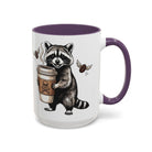 White ceramic mug with a purple interior and handle, featuring a raccoon holding a coffee cup.