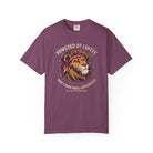 Purple t-shirt featuring a graphic of a lion wearing a bandana with the text Powered by Coffee.