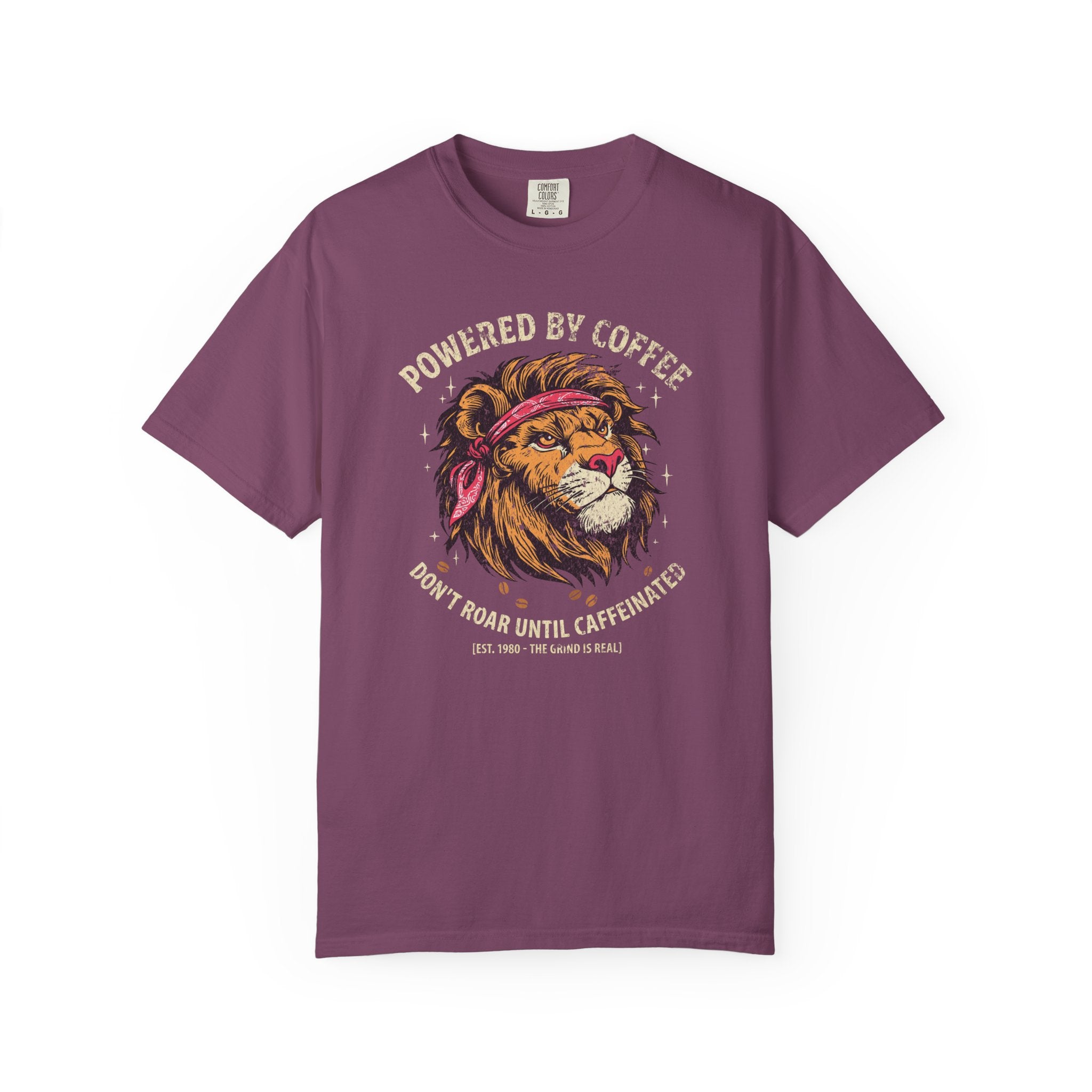 Purple t-shirt featuring a graphic of a lion wearing a bandana with the text Powered by Coffee.