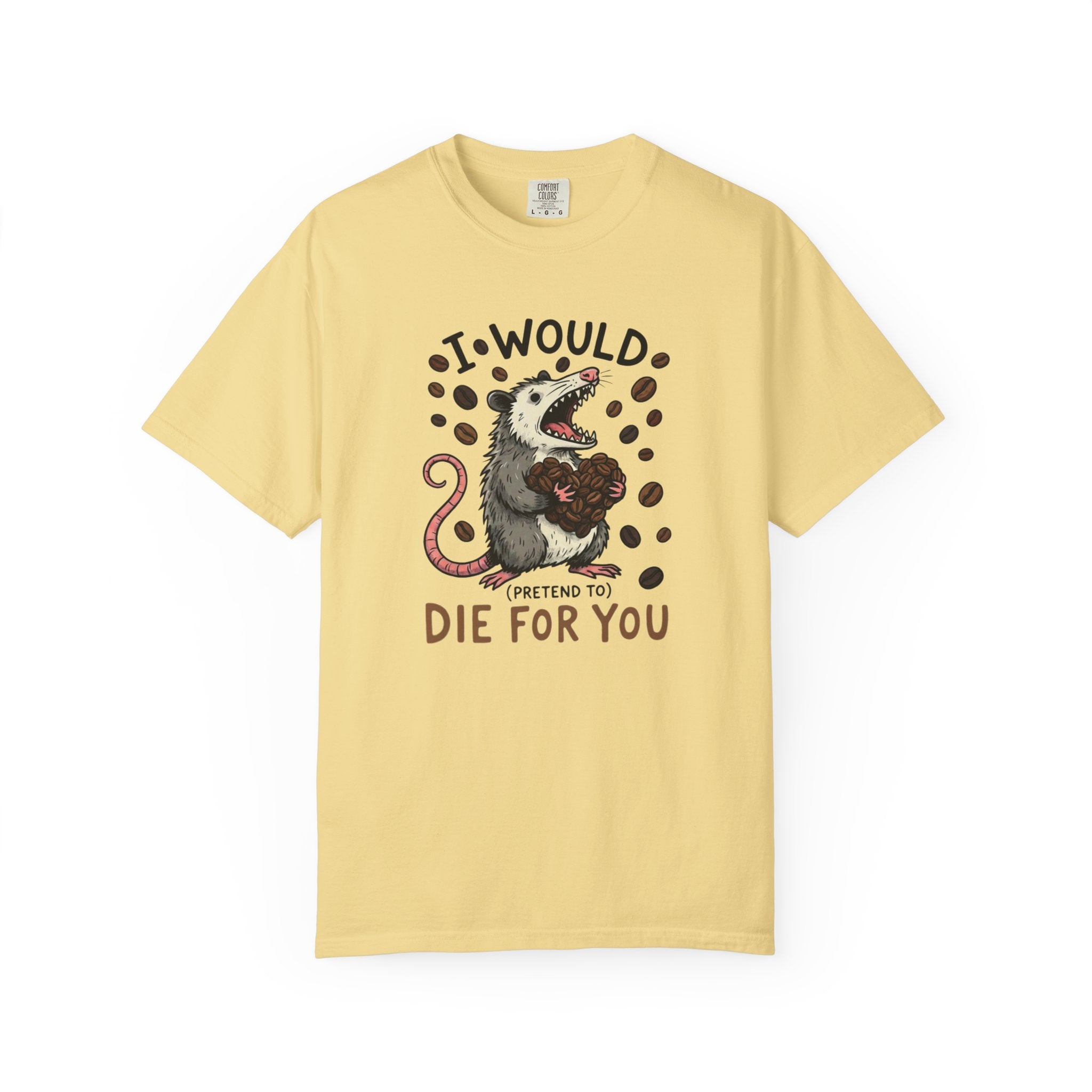 A light yellow cotton t-shirt featuring a graphic of an opossum holding a heart made of coffee beans.