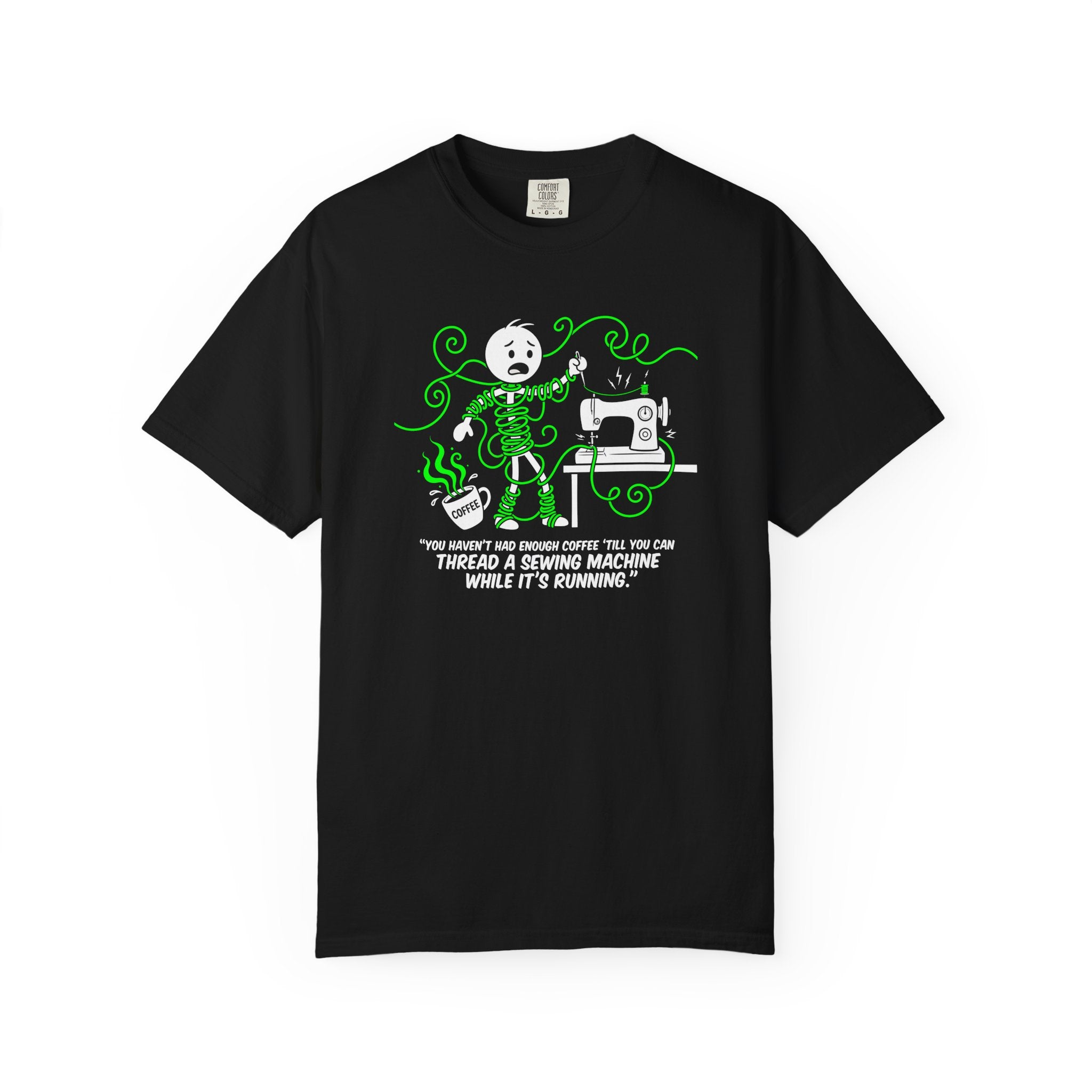 Black t-shirt with a cartoon of a person tangled in thread while sewing and drinking coffee.
