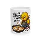 White coffee mug featuring a tired chick wearing an apron and cooking coffee-art style eggs.