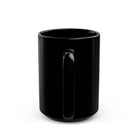 A plain black ceramic coffee mug viewed from the side, showing the handle.