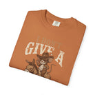 Orange t-shirt featuring a distressed graphic of a cowboy rat riding a donkey.