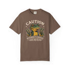 Brown t-shirt featuring a graphic of a frog making peace signs with the text Caution No Filter.