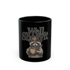Black ceramic mug featuring a raccoon in a cowboy hat and bandana holding a coffee cup.