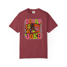 Maroon t-shirt featuring a retro, psychedelic graphic that says Decaf Is A Joke.