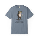 A blue garment-dyed t-shirt featuring a graphic of a frog holding a coffee mug with text below.