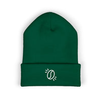 A dark green cuffed knit beanie featuring a small white embroidered coffee bean icon.