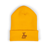 Yellow cuffed knit beanie with embroidered coffee cup detail.