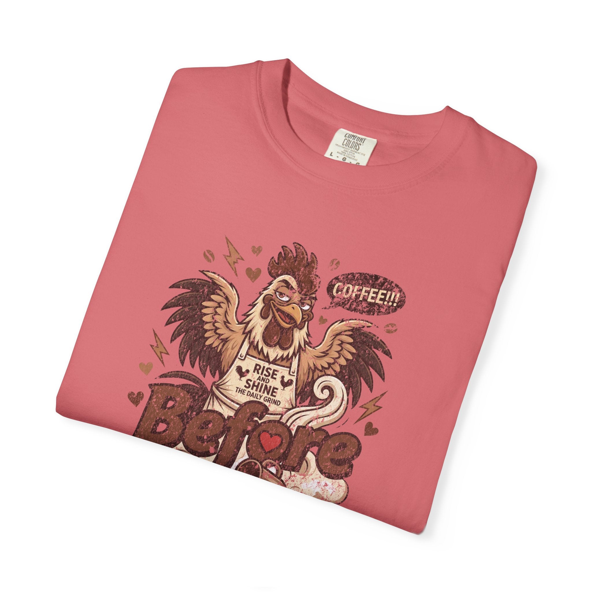 A folded pink unisex t-shirt featuring a distressed graphic of a rooster wearing an apron.