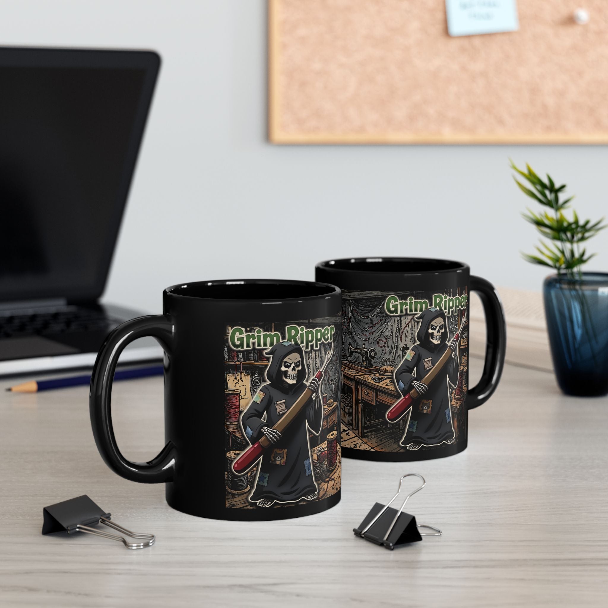 Two black ceramic mugs featuring a Grim Ripper sewing illustration on a desk with office supplies.