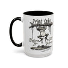 White ceramic mug with black handle and rim, featuring a frog hanging from a branch over a gator.