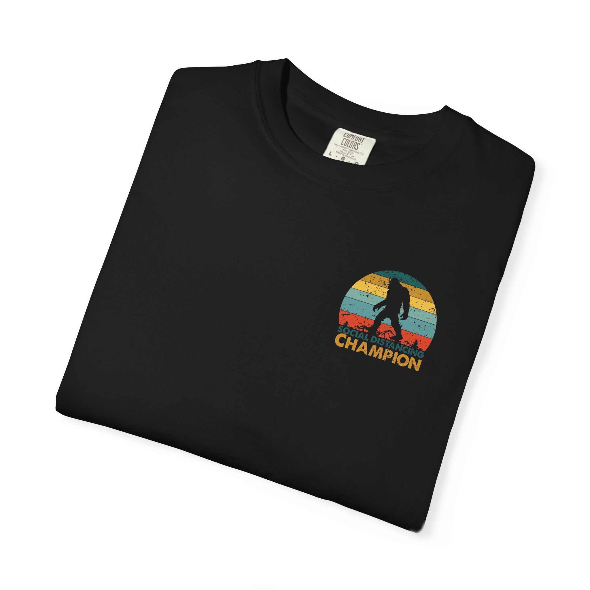 Black t-shirt featuring a retro Bigfoot graphic with the text Social Distancing Champion.