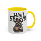 White ceramic mug with a yellow handle and rim, featuring a raccoon in a cowboy hat holding a mug.
