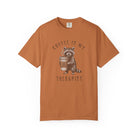 Orange unisex cotton t-shirt featuring a raccoon holding a coffee cup with a skull and crossbones.
