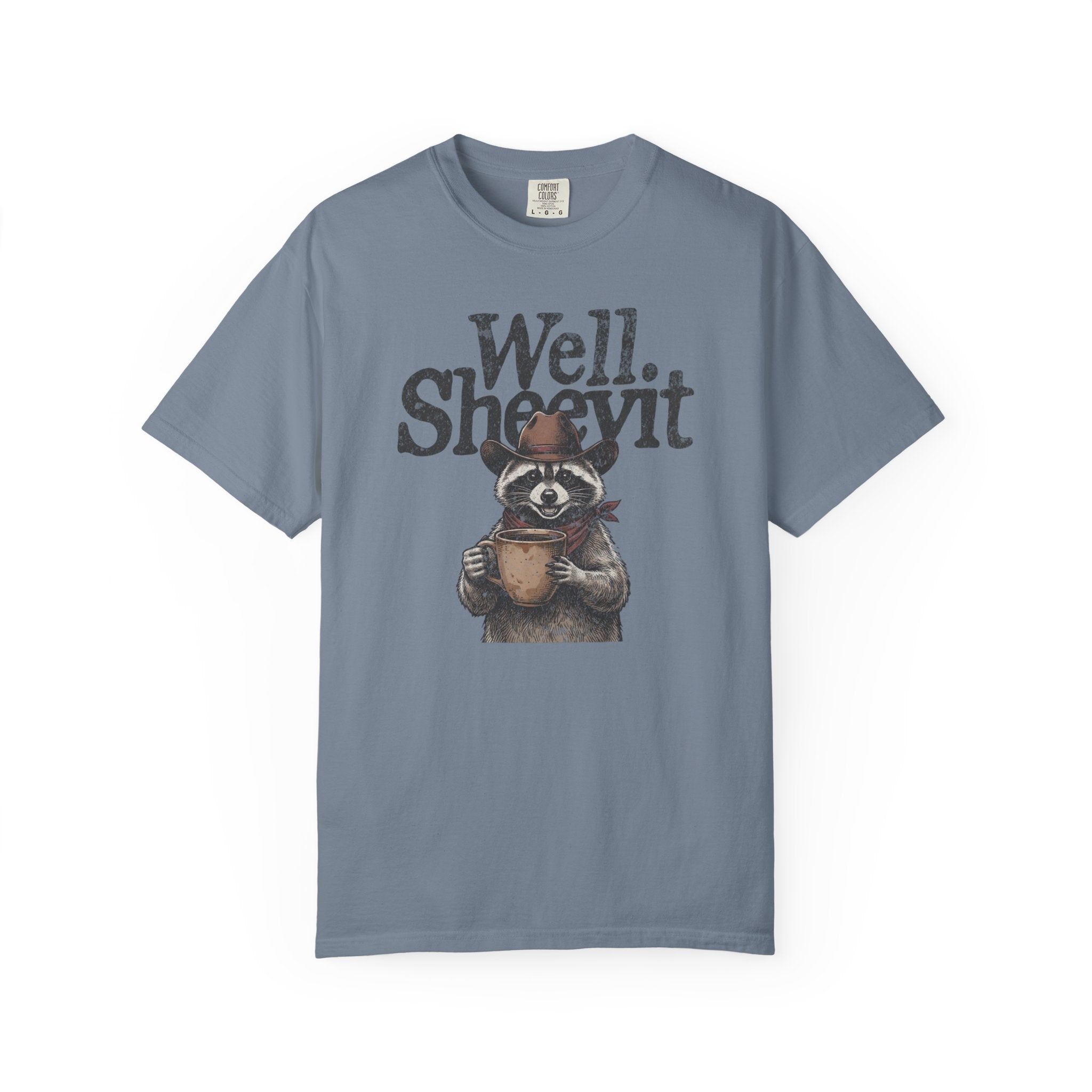 Blue t-shirt featuring a graphic of a raccoon wearing a cowboy hat and bandana, holding a mug.
