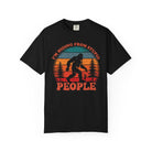 A black t-shirt featuring a vintage-style graphic of Bigfoot with the text I'm Hiding From Stupid People.