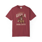 Maroon t-shirt featuring a graphic of a rat in a cowboy hat riding a donkey holding coffee.