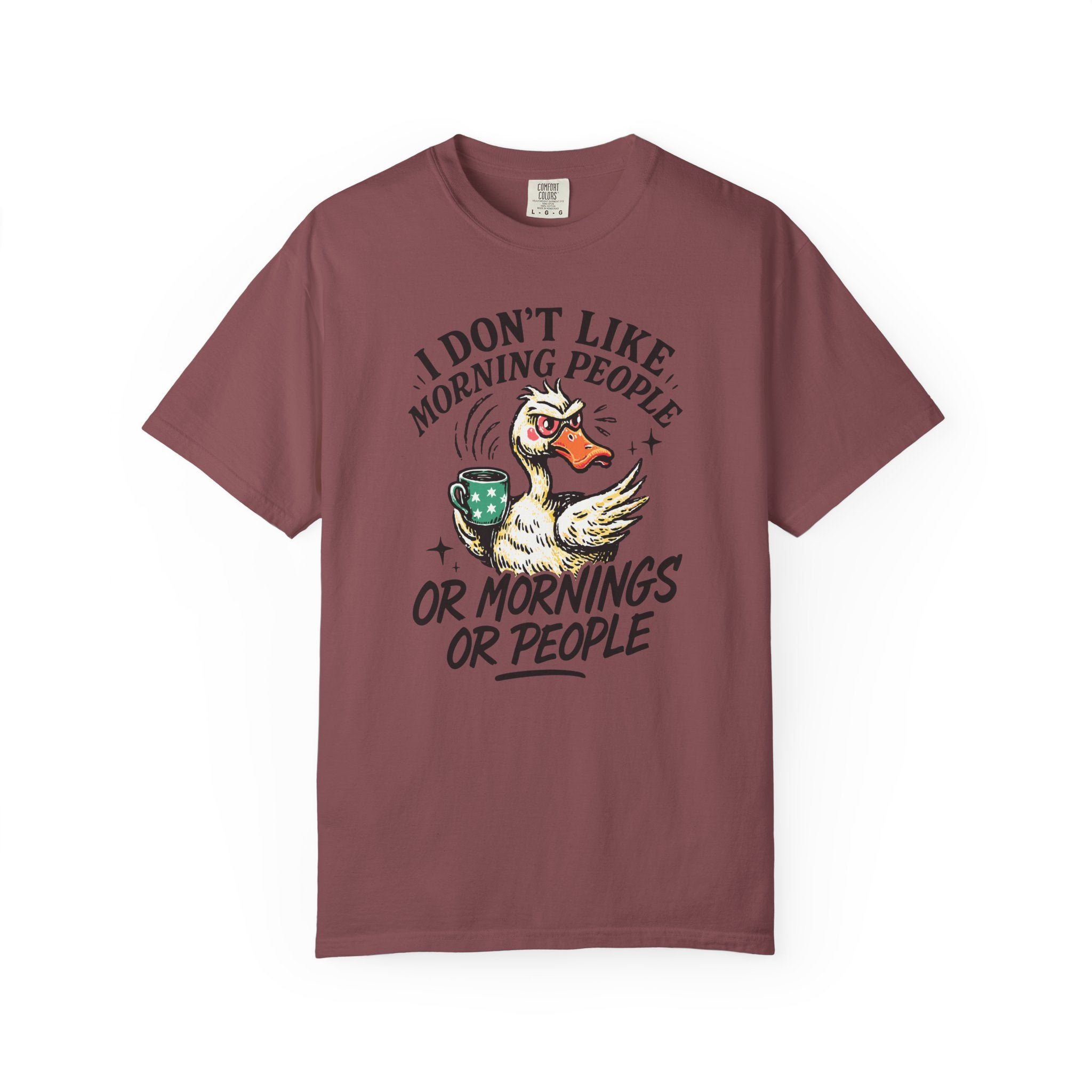 A maroon t-shirt featuring a grumpy duck holding a coffee mug with the text I Don't Like Morning People.