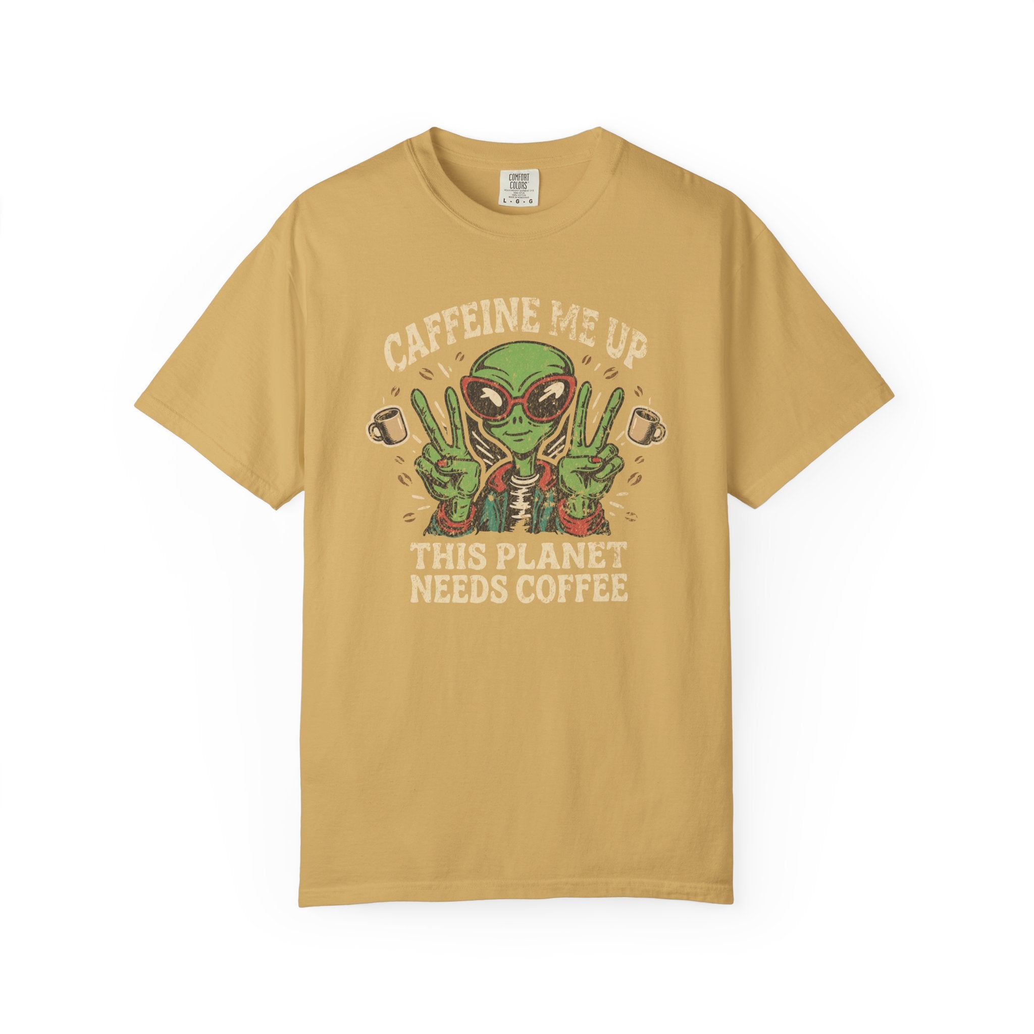 Mustard yellow unisex t-shirt with a distressed graphic of an alien making peace signs with coffee.