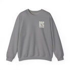 A grey crewneck sweatshirt featuring the text Drip With Sarcasm printed on the left chest.