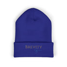 A royal blue cuffed beanie with "BREVITY Brew" embroidered in gold and blue.