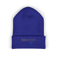 A royal blue cuffed beanie with "BREVITY Brew" embroidered in gold and blue.