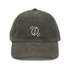 A dark olive green corduroy dad hat featuring an embroidered white coffee bean icon on the front.
