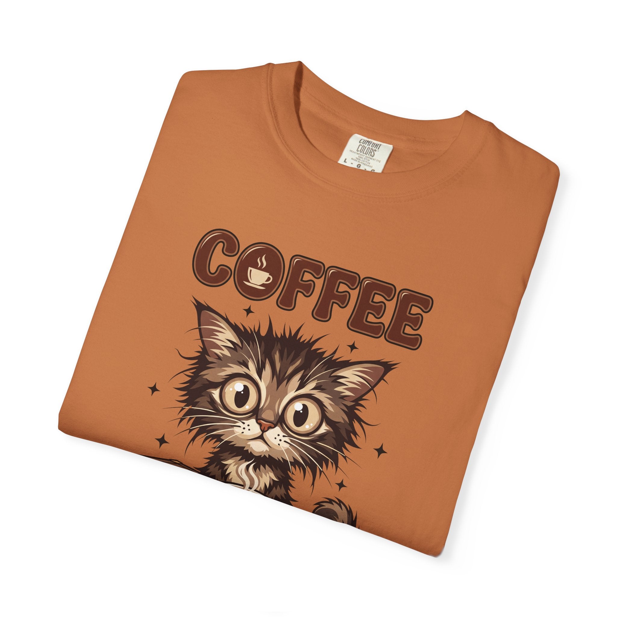 Folded orange unisex cotton t-shirt featuring a graphic of a wide-eyed kitten and the word COFFEE.