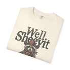 Cream-colored t-shirt featuring a distressed graphic of a raccoon in a cowboy hat holding coffee.