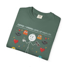 Green t-shirt with a distressed graphic of a stick figure holding coffee and a game controller.
