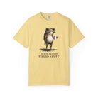 A light yellow cotton t-shirt featuring a graphic of a frog holding a coffee mug.