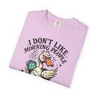 Light pink t-shirt featuring a grumpy duck holding a coffee mug with the text I DON'T LIKE MORNING