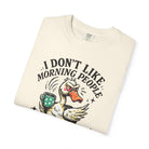 Cream-colored t-shirt featuring a graphic of an angry duck holding a coffee mug.