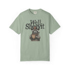 Sage green t-shirt featuring a graphic of a raccoon in a cowboy hat holding a coffee mug.