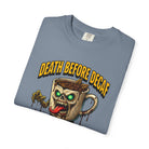 A folded blue unisex t-shirt featuring a graphic of a zombie coffee mug with the text Death Before Decaf.