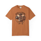 Rust-colored t-shirt featuring a graphic of a cowboy rooster pouring coffee into a mug.
