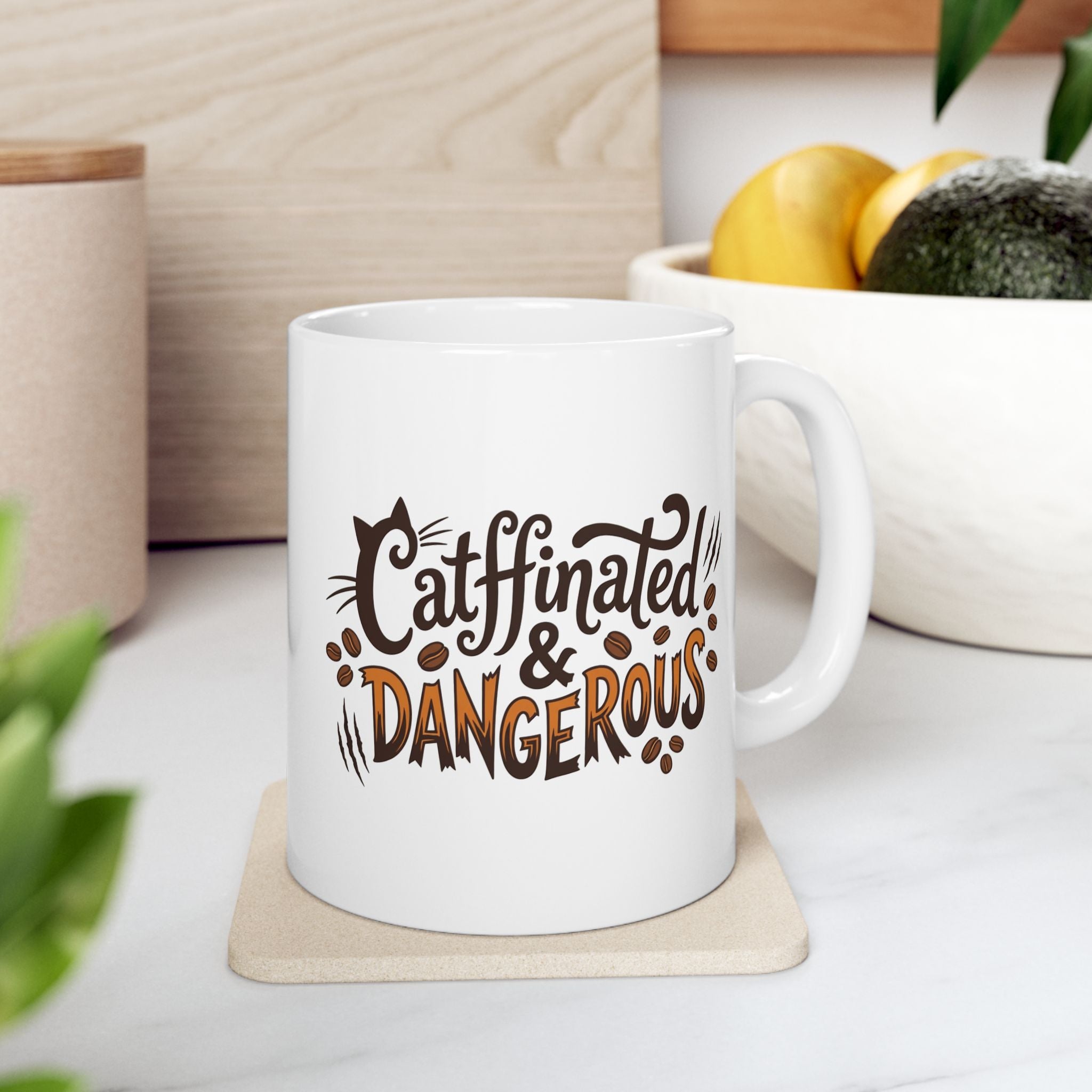 White ceramic coffee mug with Catffinated & Dangerous text and cat-themed graphics.