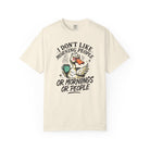 Cream-colored t-shirt with a graphic of an angry duck holding a coffee mug.