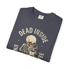 Dark grey t-shirt with a distressed graphic of a skeleton wearing sunglasses drinking coffee.