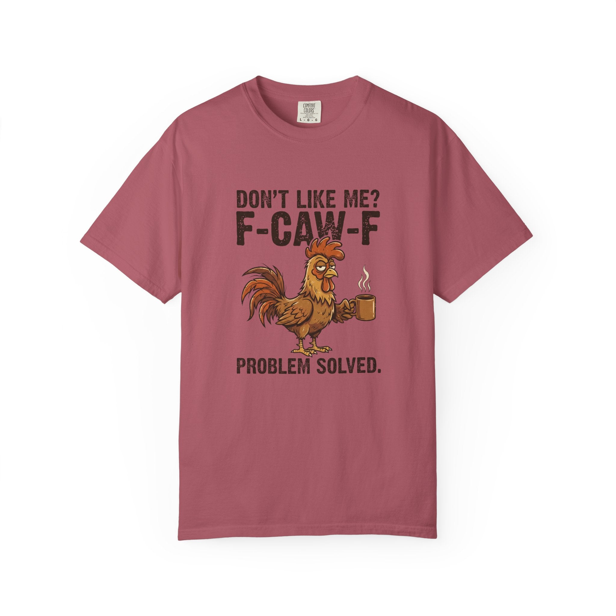 A dusty rose t-shirt featuring a graphic of a rooster holding a coffee mug with sarcastic text.