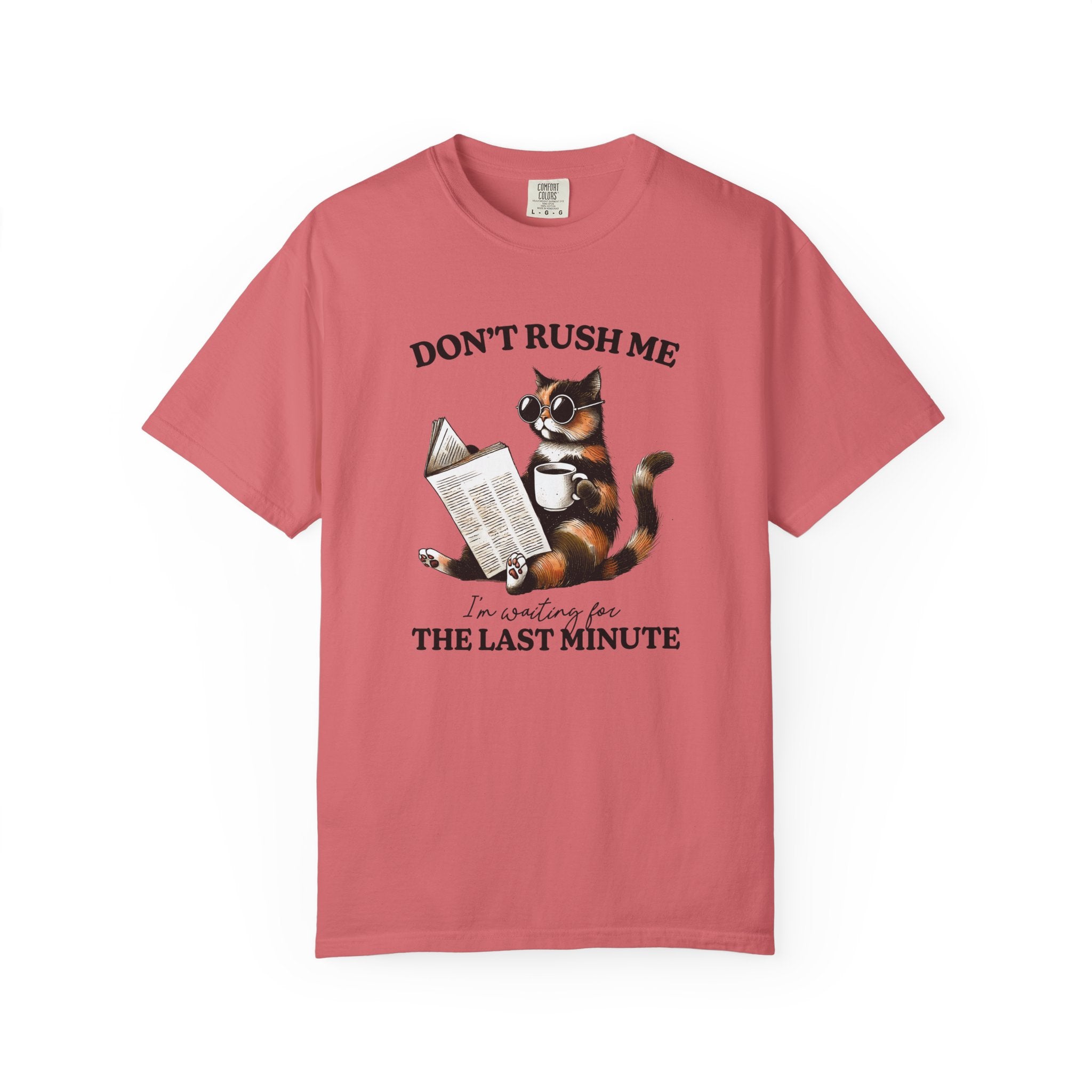 A vintage-style coral cotton t-shirt featuring a graphic of a cat reading a book with coffee.