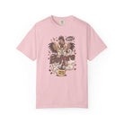 Light pink unisex t-shirt featuring a distressed graphic of a rooster drinking coffee.