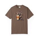 Brown Comfort Colors unisex t-shirt featuring a graphic of a raccoon holding a skull-logo coffee cup.